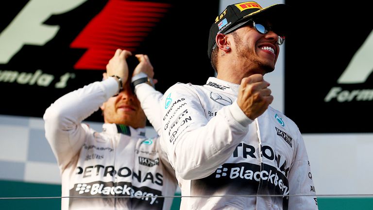 Lewis Hamilton of Great Britain and Mercedes GP celebrates on the podium next to Nico Rosberg of Germany and Mercedes GP 