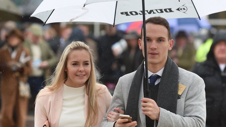 Racegoers arrive in the rain on Gold Cup Day during the Cheltenham Festival at Cheltenham Racecourse. PRESS ASSOCIATION Photo. Picture date: Friday March 1