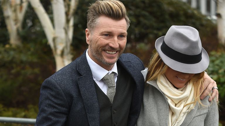 Robbie Savage and his wife Sarah arrive on Gold Cup Day during the Cheltenham Festival at Cheltenham Racecourse. PRESS ASSOCIATION Photo. Picture date: Fri