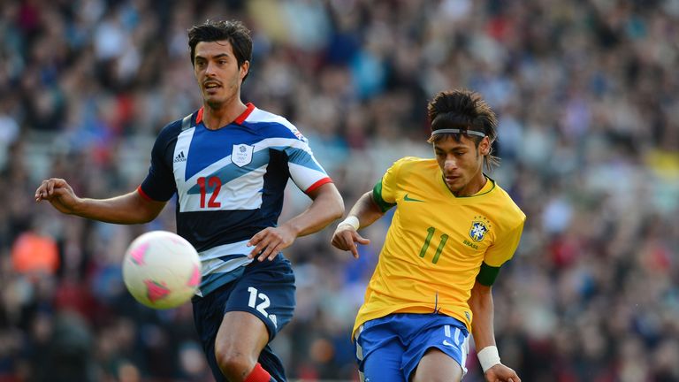 Brazil forward Neymar (R) shoots past Great Britain defender James Tomkins during their London 2012 Olympic games warm up football match