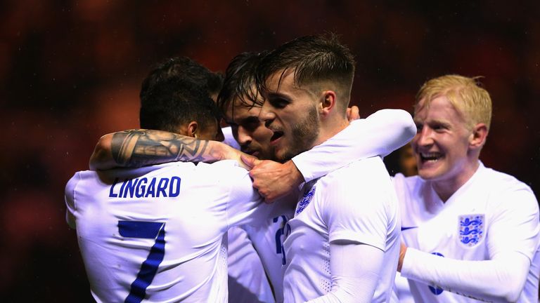 Jesse Lingard of England celebrates with team mates after scoring their first goal during the international friendly be
