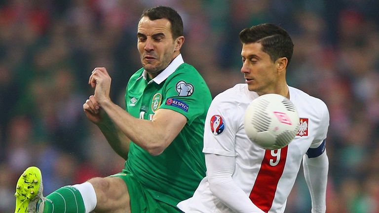 John O'Shea of Republic of Ireland and Robert Lewandowski of Poland compete for the ball