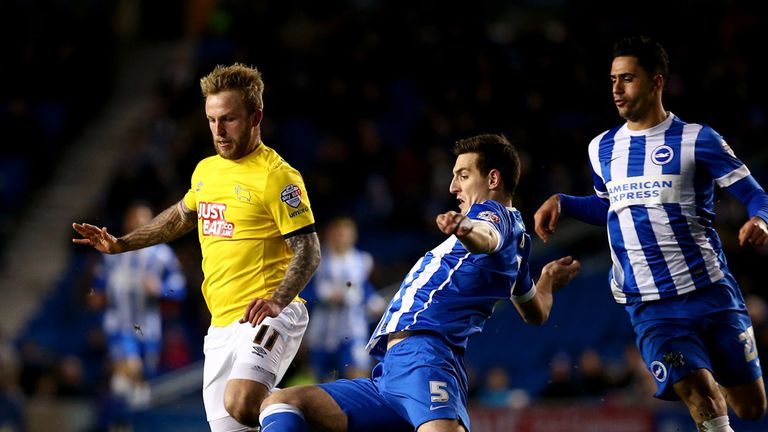 Johnny Russell is tackled by Lewis Dunk 