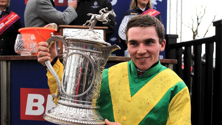 Jonathan Burke celebrates winning The Betfred Midlands Grand National