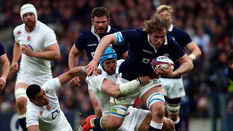 Jonny Gray of Scotland is tackled by James Haskell of England