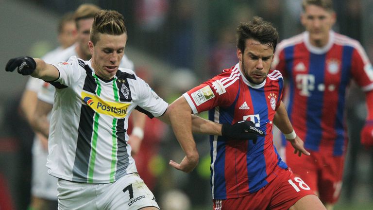 Juan Bernat of Bayern Munich challenges Borussia Moenchengladbach's Patrick Hermann