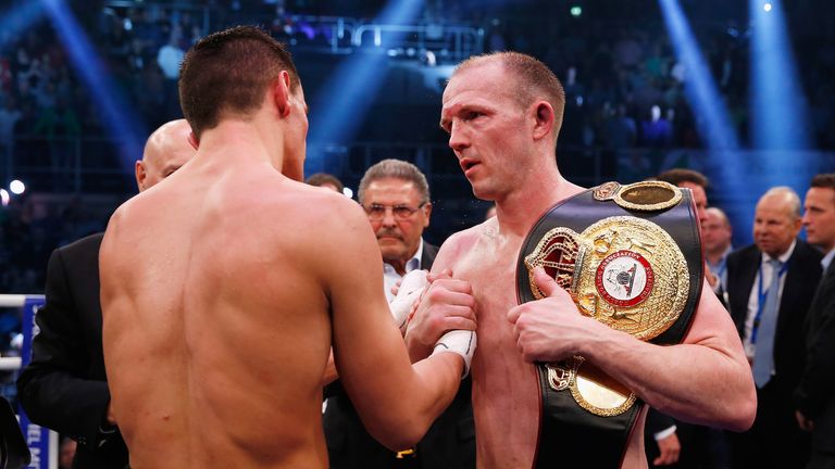 Juergen Braehmer consoles Robin Krasniqi after defending his WBA light heavyweight title