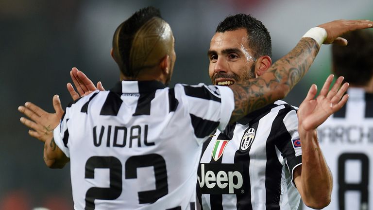 Juventus' Argentinian forward Carlos Tevez and Arturo Vidal celebrate during the Round of 16, second-leg UEFA Champions League match v Borussia Dortmund