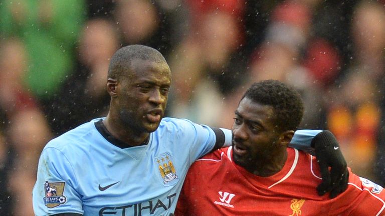 Manchester City's Ivorian midfielder Yaya Toure (L) and Liverpool's Ivorian defender Kolo Toure (R) leave the pitch at Anfield