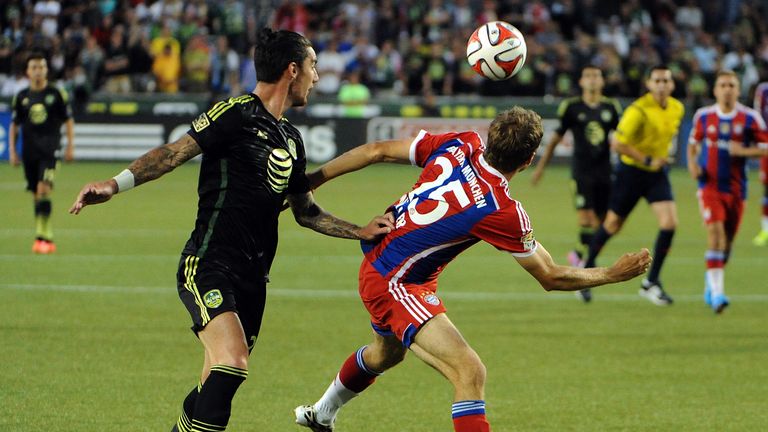 Liam Ridgewell of the MLS All-Stars battles for a ball with Thomas Muller of Bayern Munich 