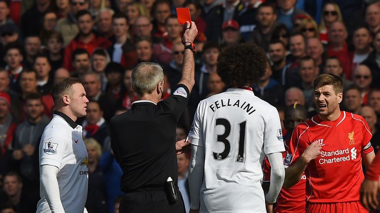Liverpool's Steven Gerrard is shown a red card by referee Martin Atkinson against Manchester United