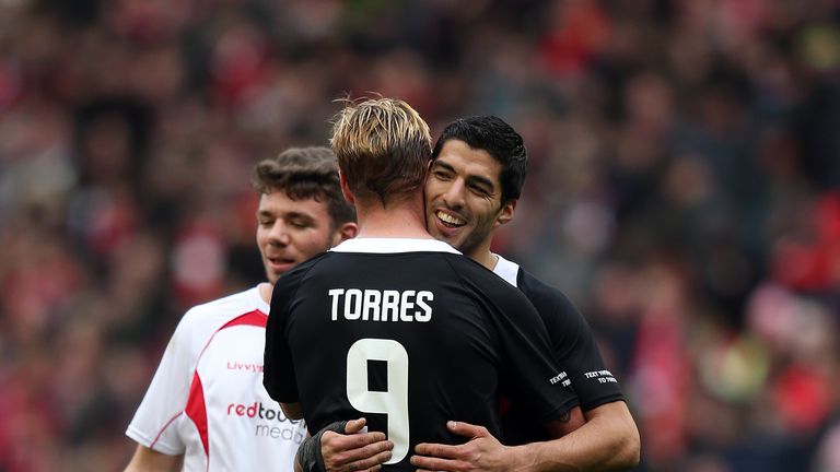  Luis Suarez of the Gerrard XI embraces team-mate Fernando Torres at full time following the Liverpool All-Star Charity match at Anfield.