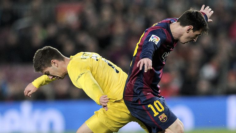 Barcelona's Lionel Messi vies with Villarreal's Luciano Vietto during the Spanish Copa del Rey semi-final first leg at the Camp Nou on February 11, 2015