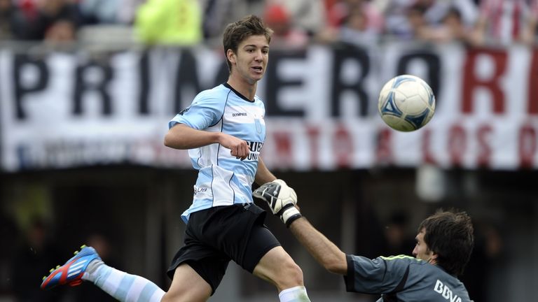 Racing's Luciano Vietto vies for the ball with River Plate goalkeeper Marcelo Barovero during their Argentine First Division match in September 2012