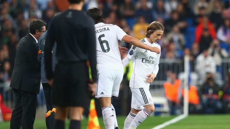 Luka Modric replaces Sami Khedira during the UEFA Champions League Round of 16 match between against FC Schalke 04 at the Santiago Bernabeu.