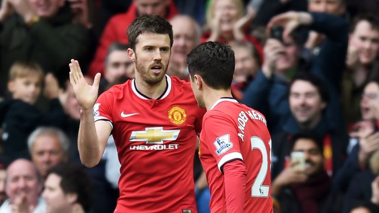 Michael Carrick (L) of Manchester United is congratulated by teammate Ander Herrera