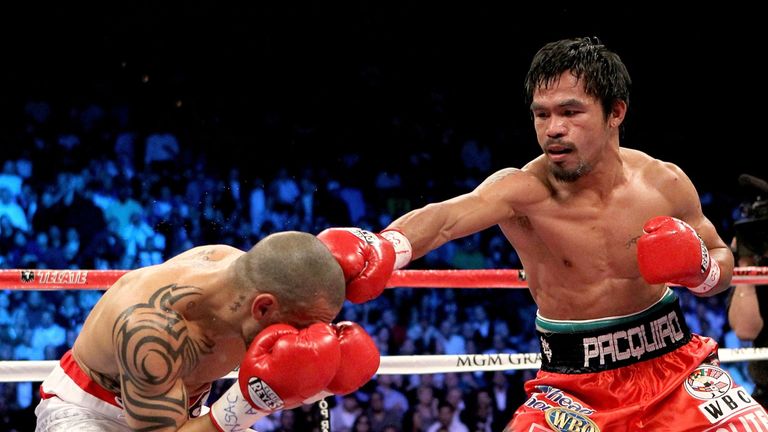 LAS VEGAS - NOVEMBER 14:  (R-L) Manny Pacquiao throws a right to the head of Miguel Cotto during their WBO welterweight title fight at the MGM Grand Garden
