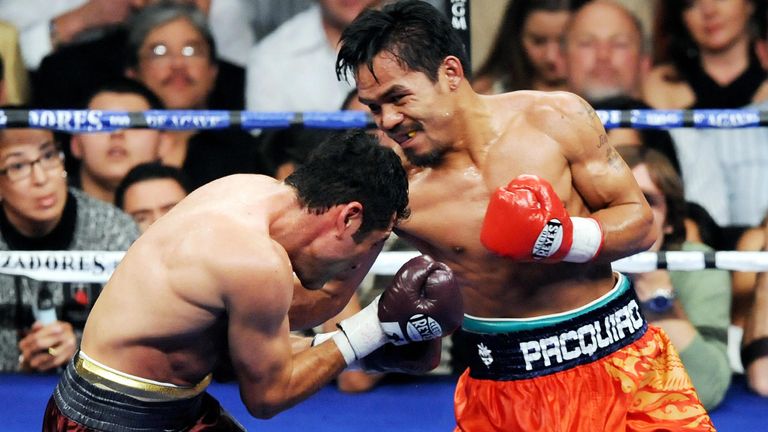 Manny Pacquiao (R) of the Philippines connects a punch on the face of Oscar de la Hoya of US during their welterweights showdown at the MGM Grand Garden Ar