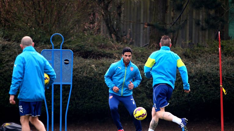 Mikel Arteta and Mathieu Debuchy trained away from the main group on Monday