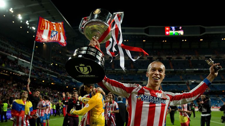 MADRID, SPAIN - MAY 17: Joao Miranda of Atletico de Madrid holds the trophy in celebration after the Copa del Rey Final match between Real Madrid CF and Cl