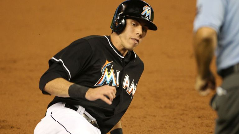 Christian Yelich of the Miami Marlins slides into third base during the first inning against the Philadelphia Phillies at Marlins Park