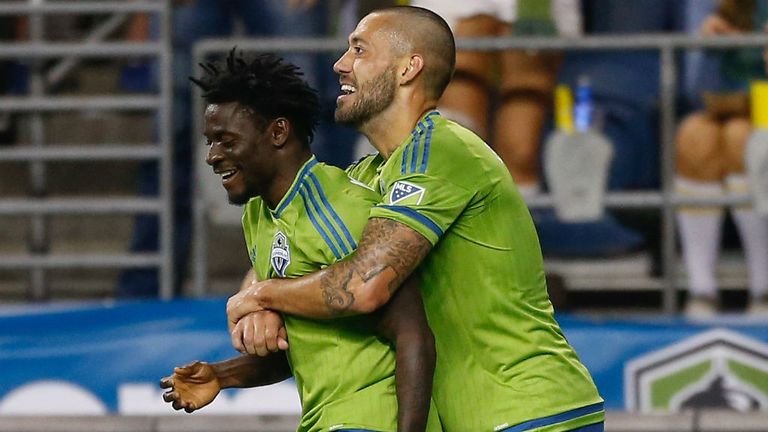Clint Dempsey of the Seattle Sounders hugs Obafemi Martins after scoring against the New England Revolution