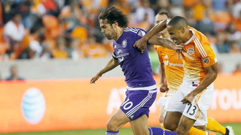 HOUSTON, TX - MARCH 13:  Kaka #10 of the Orlando City SC battles for the ball with Ricardo Clark #13 of the Houston Dynamo during their game at BBVA Compas
