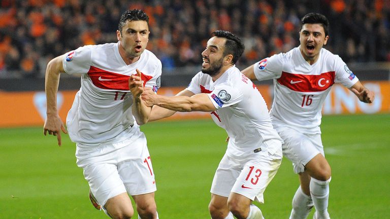 Turkey's Forward Burak Yilmaz celebrates with teammates after scoring against Netherlands