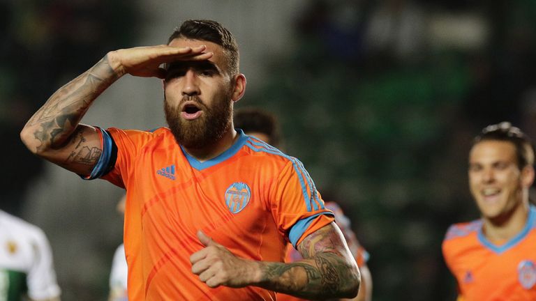 Valencia's Argentinian defender Nicolas Otamendi (L) celebrates his goal