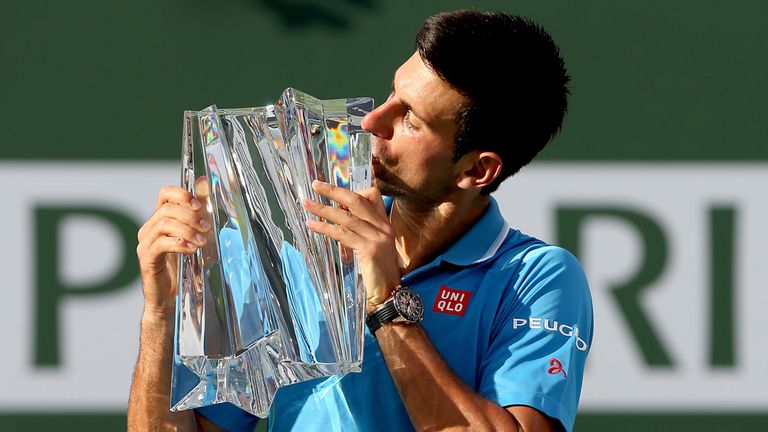 Novak Djokovic poses with the trophy after victory at Indian Wells