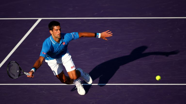 Novak Djokovic of Serbia stretches to play a forehand volley against Steve Darcis of Belgium in their third round match during the Miami Open