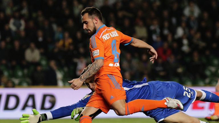 Valencia's forward Paco Alcacer vies with Elche goalkeeper Przemyslav Tyton