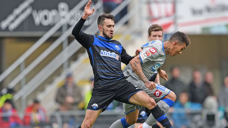 Lukas Rupp (L) of Paderborn tackles Roberto Firmino of Hoffenheim