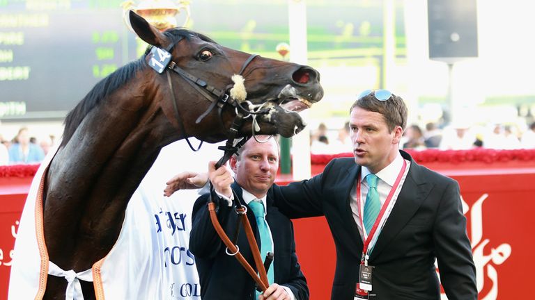 DUBAI, UNITED ARAB EMIRATES - MARCH 28:  Former England international footballer Michael Owen and trainer Tom Dascombe pose with Brown Pather after winning