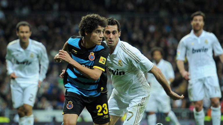 Philippe Coutinho of Espanyol shields Alvaro Arbeloa of Real Madrid from the ball during the La Liga match in March 2012