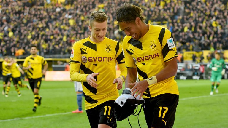 Pierre-Emerick Aubameyang celebrates with Marco Reus after scoring his teams first goal during match between Borussia Dortmund and FC Schalke 04