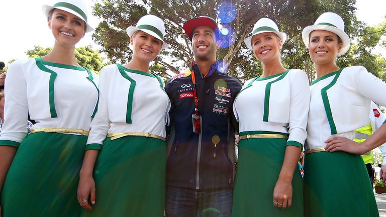 Daniel Ricciardo of Australia and Infiniti Red Bull Racing poses with grid girls as he arrives at the track during previe