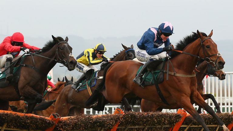 CHELTENHAM, ENGLAND - MARCH 11:  Qualando ridden by Nick Scholfield clears the last fence on their way to victory in the Fred Winter Juvenile Handicap Hurd