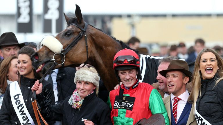 Jockey Sam Twiston-Davies celebrates with breeder Frankie Dettori (second right) after Dodging Bullets wins the Betway Queen Mother Champion Chase on Ladie