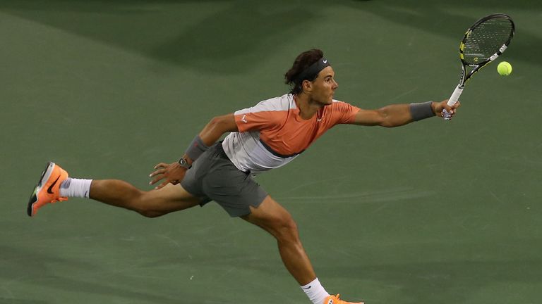 Rafael Nadal of Spain lunges for a shot by Alexandr Dolgopolov of the Ukraine during the BNP Paribas Open at Indian Wells 