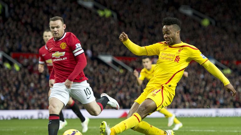 Liverpool's Raheem Sterling takes a shot at goal past Manchester United's Wayne Rooney (L) 