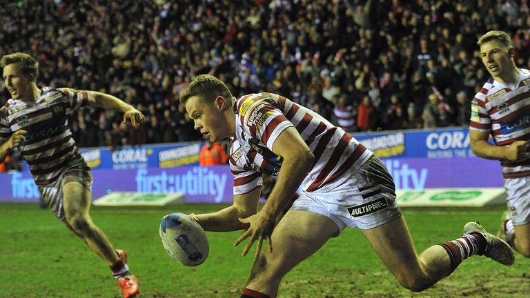 Wigan Warriors' Joe Burgess goes over for his team's second try, to tie the game at 12-12 during the World Club Series match at the DW Stadium, Wigan.