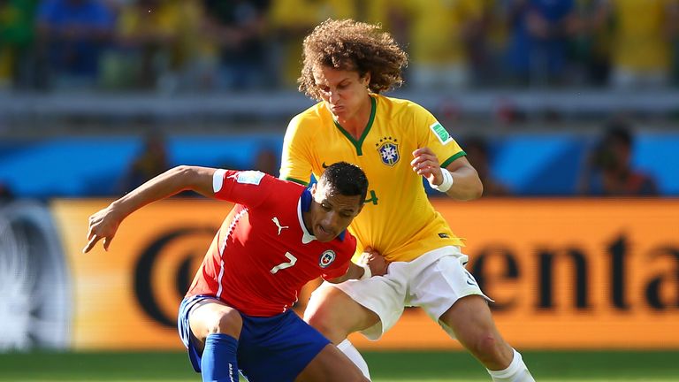 Alexis Sanchez of Chile and David Luiz of Brazil compete for the ball during the 2014 FIFA World Cup Brazil round of 16 