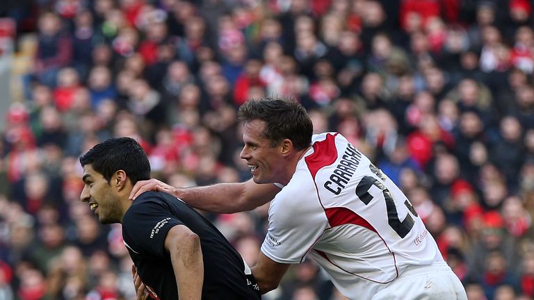 Luis Suarez of the Gerrard XI tussles with Jamie Carragher of the Carragher XI during the Liverpool All-Star Charity match.