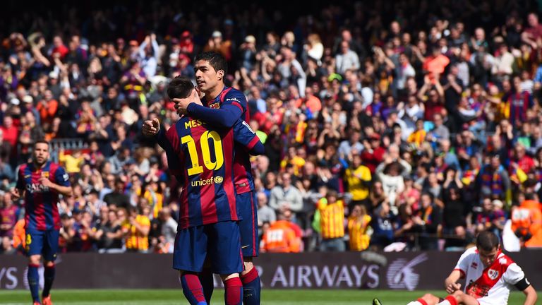 Lionel Messi of FC Barcelona celebrates with his teammate Luis Suarez of FC Barcelona after scoring his team's fourth goal du