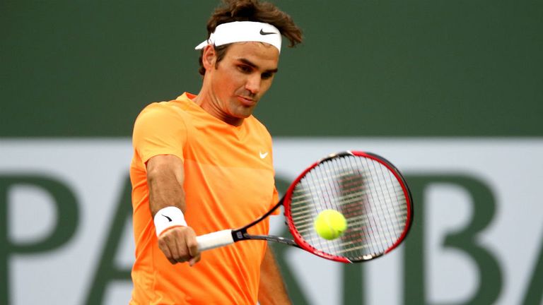 Roger Federer returns a shot to Jack Sock during at the Indian Wells Tennis 