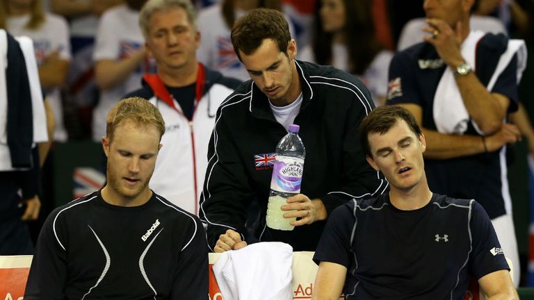 Andy Murray consoles Dominic Inglot and Jamie Murray after their doubles match against Mike and Bob Bryan