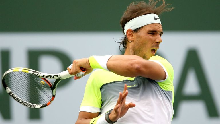 Rafael Nadal returns a shot to Gilles Simon during the BNP Paribas Open at Indian Wells
