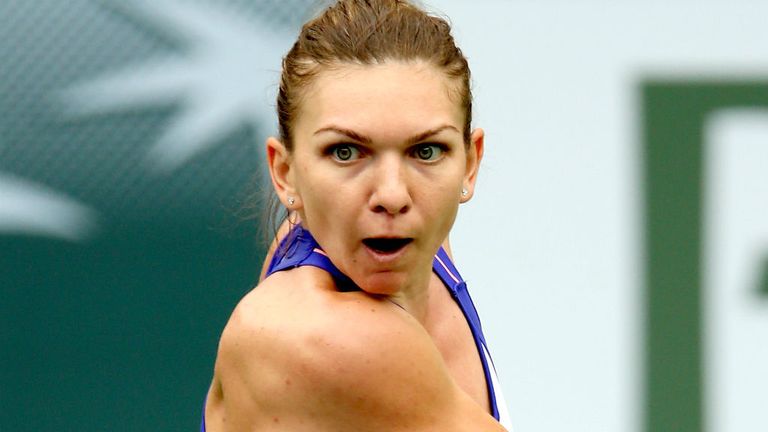 Simona Halep returns a shot to Carla Suarez Navarro during the BNP Paribas Open at Indian Wells 