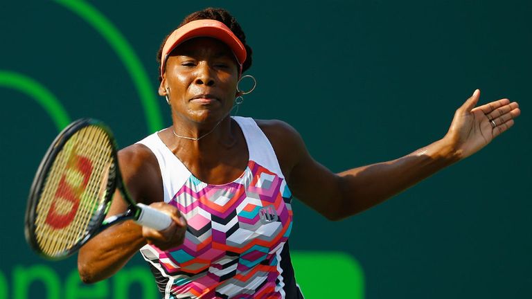 Venus Williams returns the ball to Urszula Radwanska of Poland at the Miami Open